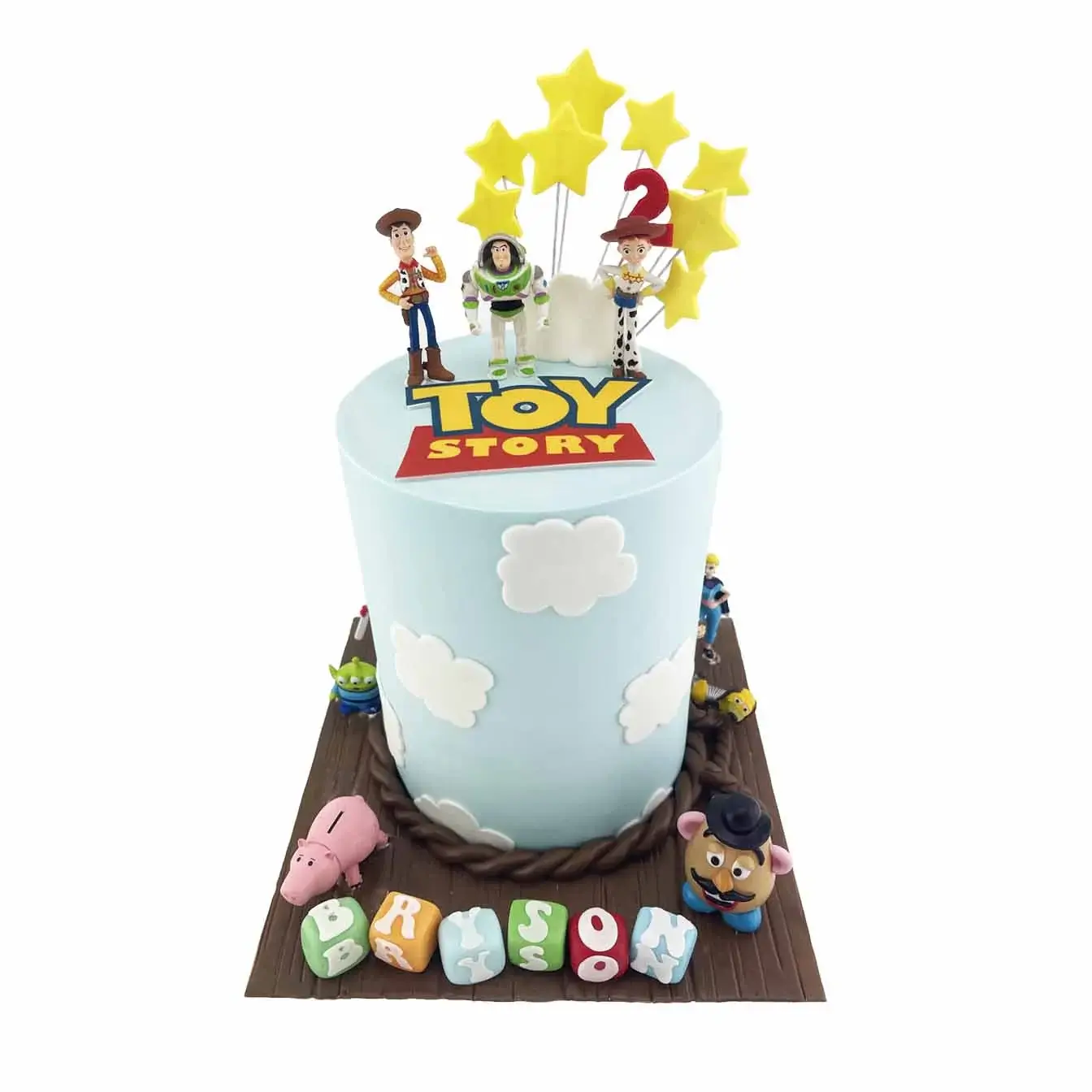 A whimsical and colorful Toy Story cake featuring Mr. Potato Head, Buzz, Woody, Bo Peep, Alien, and Slinky Dog, with intricate details and expert design.