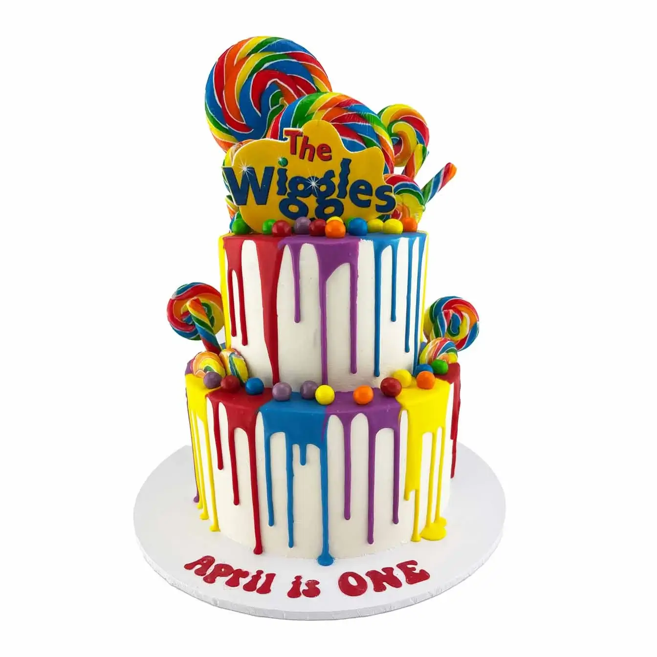 Wiggly Drip Cake Delight - A two-tier white iced cake with red, yellow, blue, and purple drips, rainbow lollipops, Skittles, and the iconic Wiggles logo, bringing the wiggly magic to your celebration.