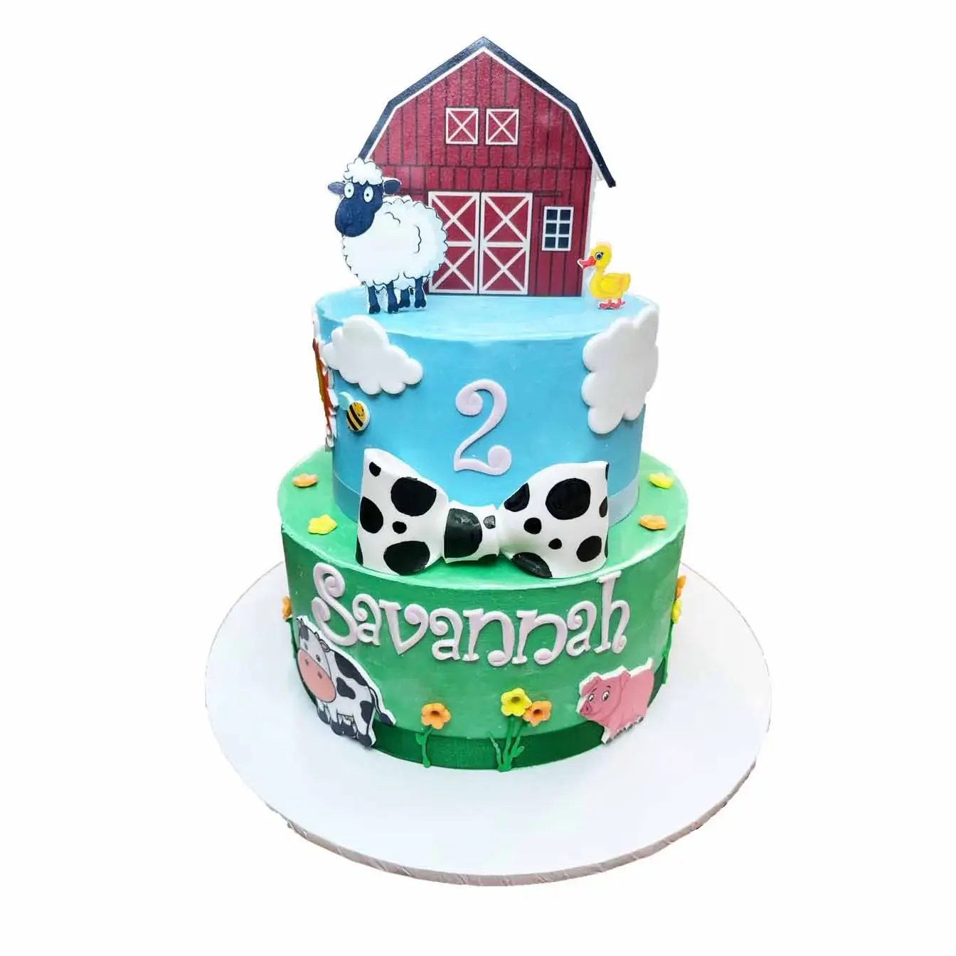 Barnyard Fun Birthday Cake - A 2-tier cake with a red barn on top and whimsical farmyard animals, a playful centerpiece for barnyard-themed birthday parties.