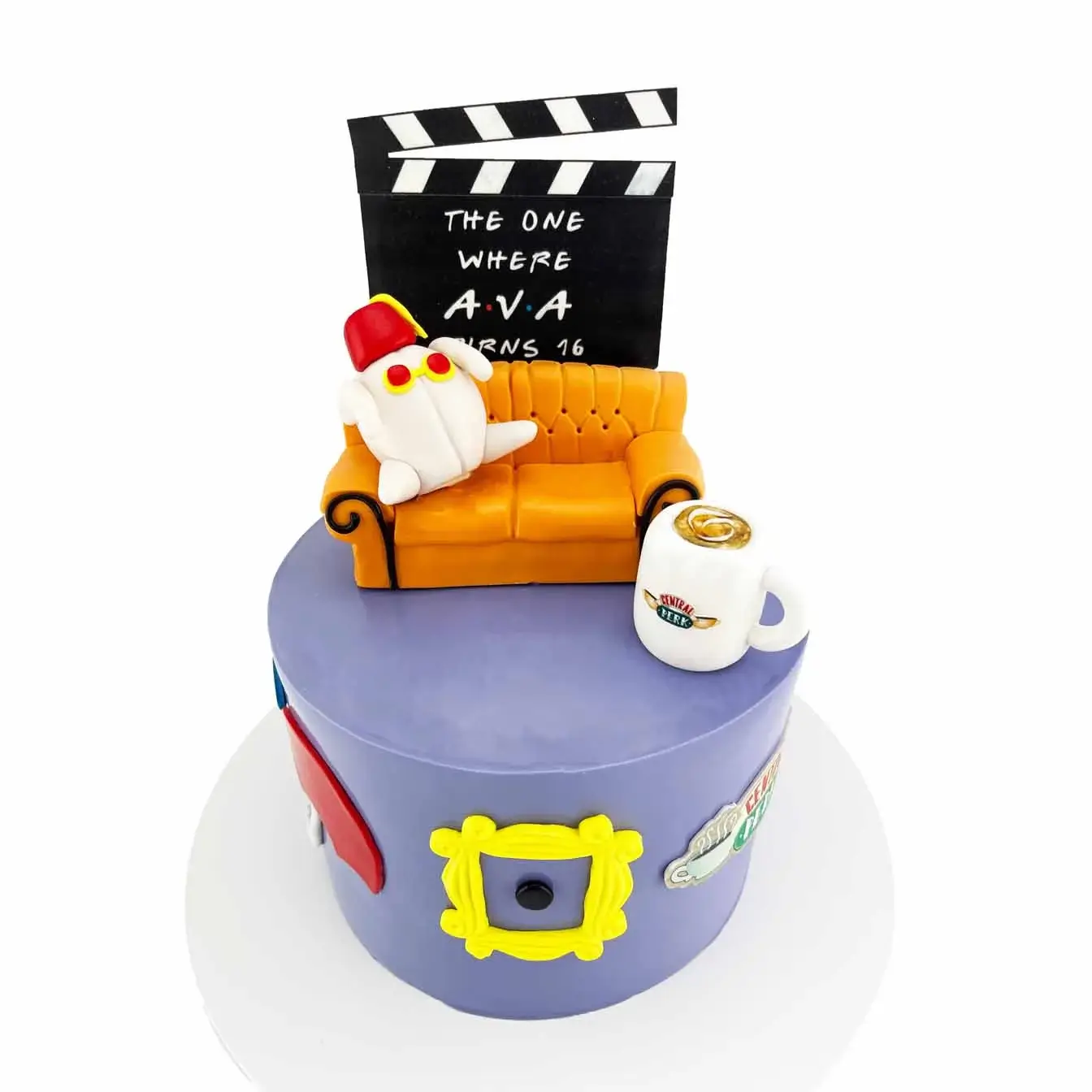 Friends-themed cake featuring a fondant replica of the iconic Friends couch, personalized clapper board, Central Perk mug, friends peep hole, and umbrellas - perfect for any celebration
